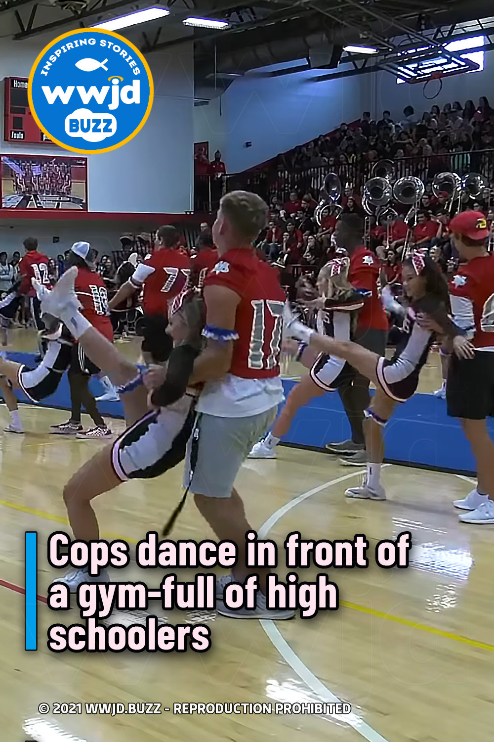 Cops dance in front of a gym-full of high schoolers